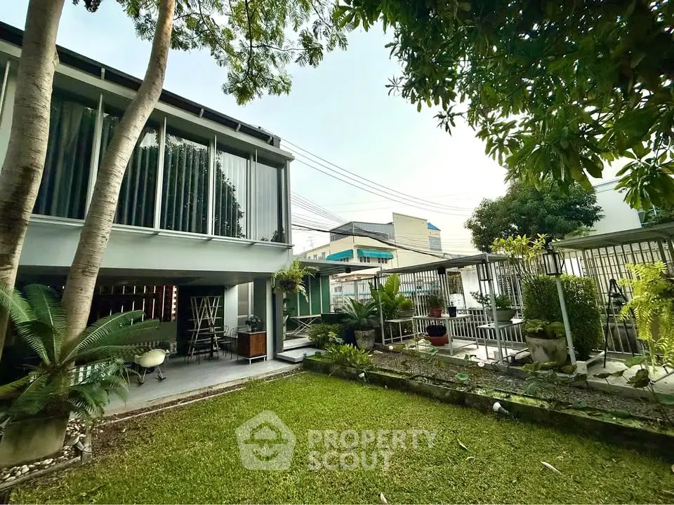 Modern home with lush garden and spacious outdoor area, perfect for relaxation and entertaining.