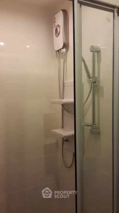 Modern bathroom shower with sleek glass door and water heater