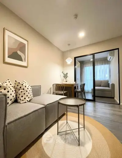 Modern living room with stylish decor and cozy dining area, perfect for relaxation and entertaining.