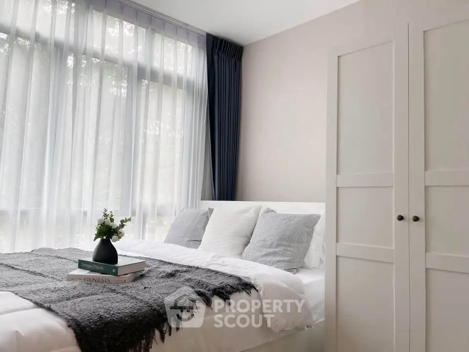 Cozy bedroom with large window and elegant decor