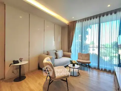 Modern living room with large window and stylish furniture, offering a bright and inviting atmosphere.