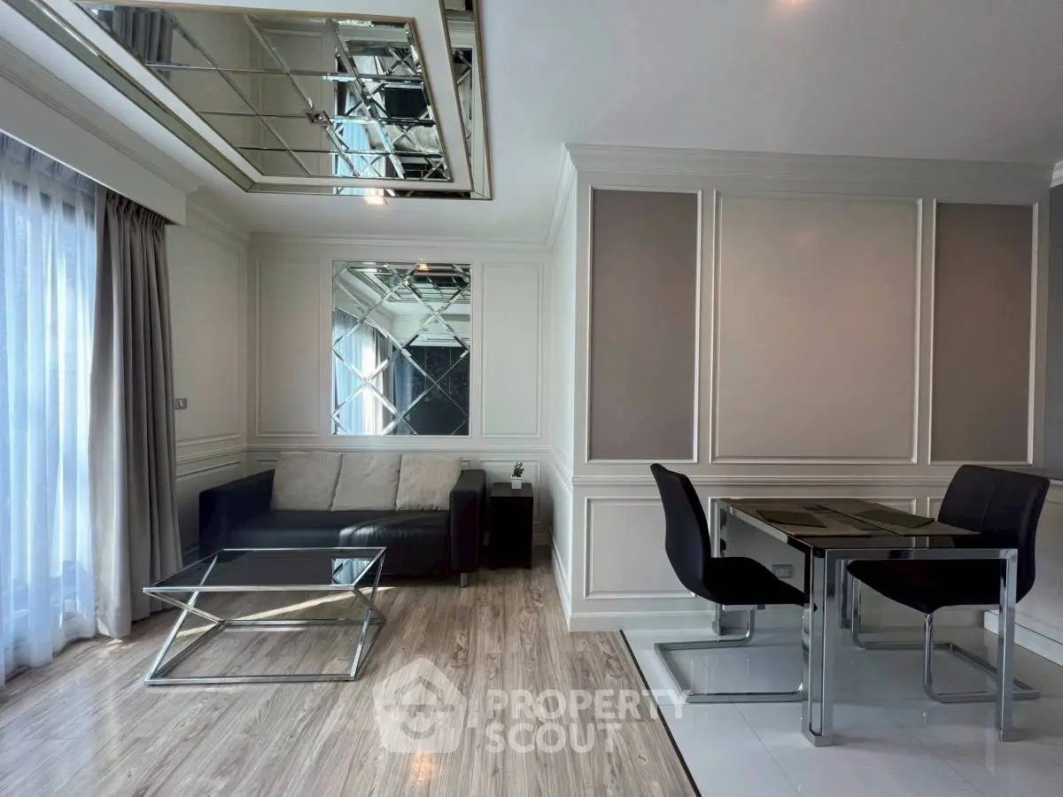 Stylish modern living room with mirrored ceiling and elegant dining area