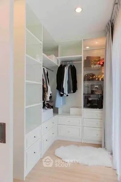Luxurious walk-in closet with ample storage and elegant design