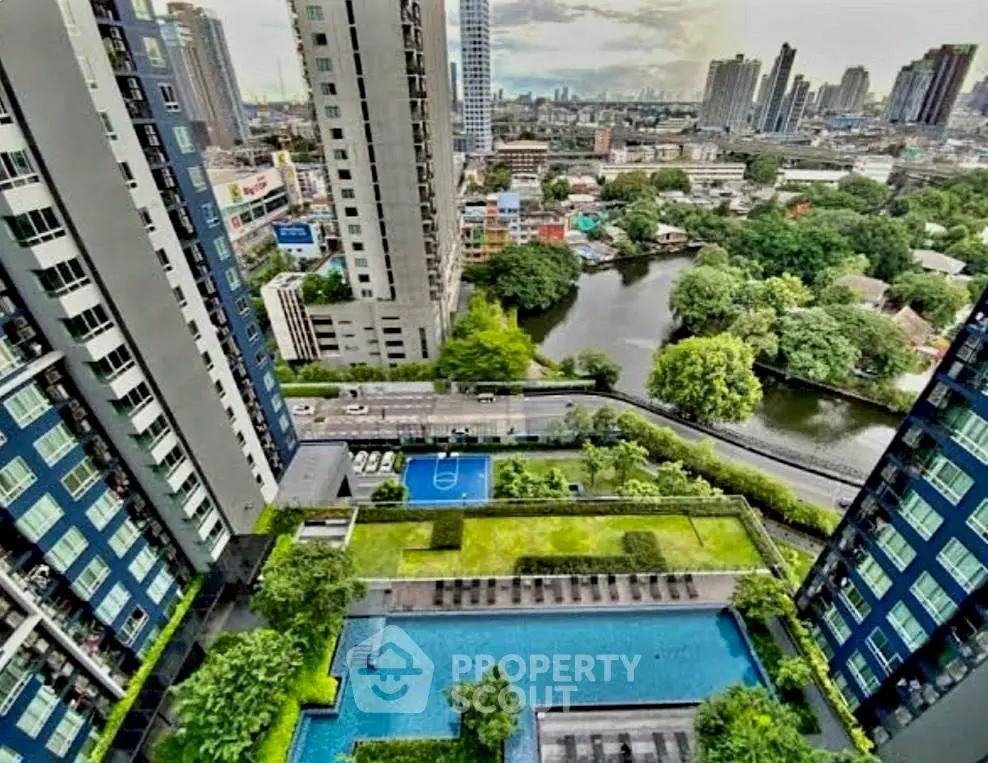 Stunning aerial view of modern high-rise buildings with lush gardens and a sparkling pool, offering a vibrant urban lifestyle.
