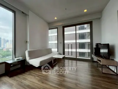 Modern living room with city view, sleek furniture, and large windows.