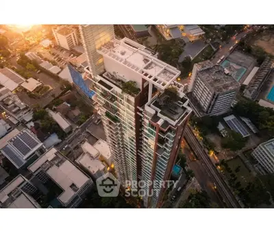 Stunning aerial view of a modern high-rise building in a bustling urban area at dusk.