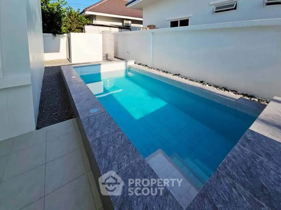 Stunning private pool in a modern residential backyard, perfect for relaxation and entertainment.