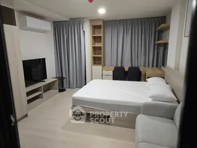 Modern studio apartment with cozy bed and stylish furniture