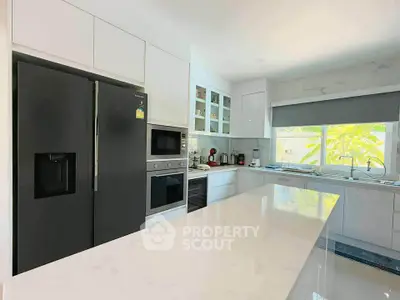 Modern kitchen with sleek appliances and large island countertop