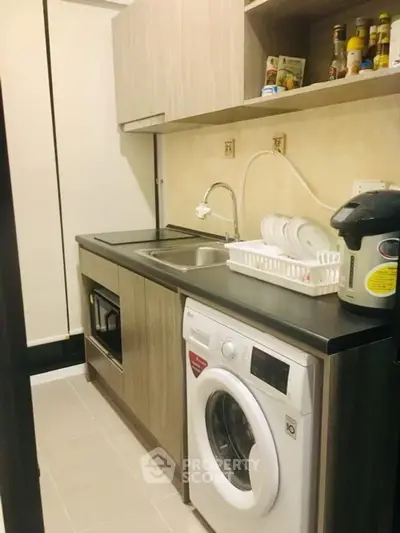 Compact kitchen with modern appliances and efficient storage solutions.