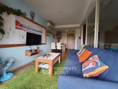 Spacious living room with modern decor and vibrant colors, featuring a cozy sofa and stylish dining area.