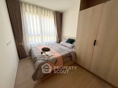 Cozy bedroom with modern decor and ample natural light