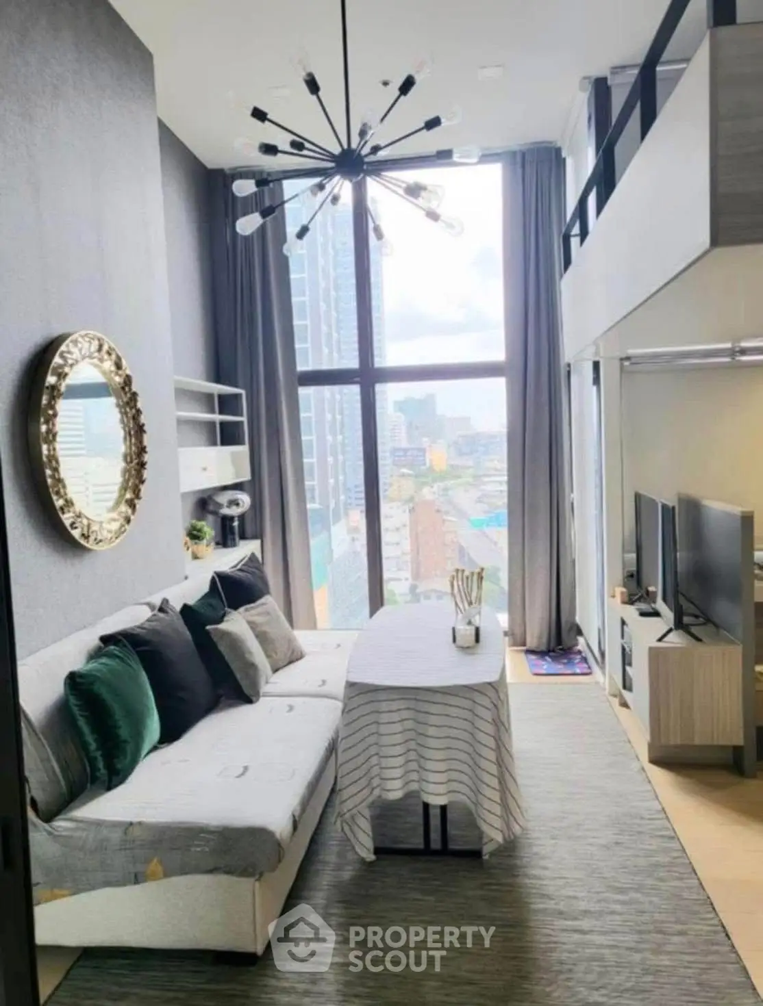 Modern loft-style living room with high ceilings and large windows offering city views.