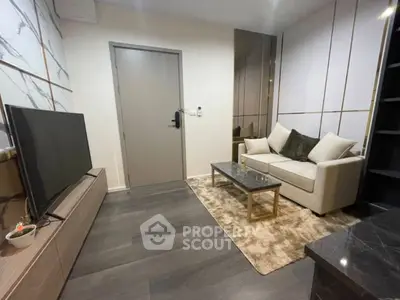 Modern living room with sleek design, featuring a cozy sofa, stylish TV setup, and elegant decor.
