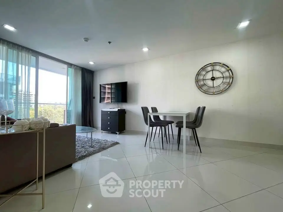 Modern living room with sleek furniture and large windows offering a stunning view.