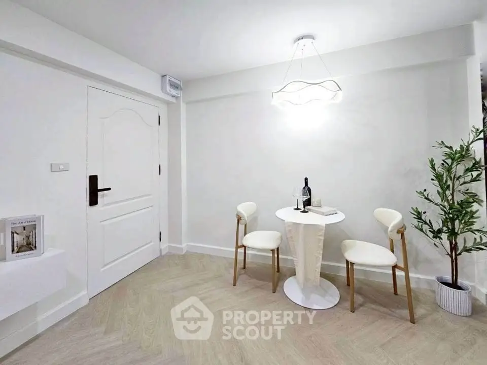 Modern minimalist dining area with elegant lighting and chic decor