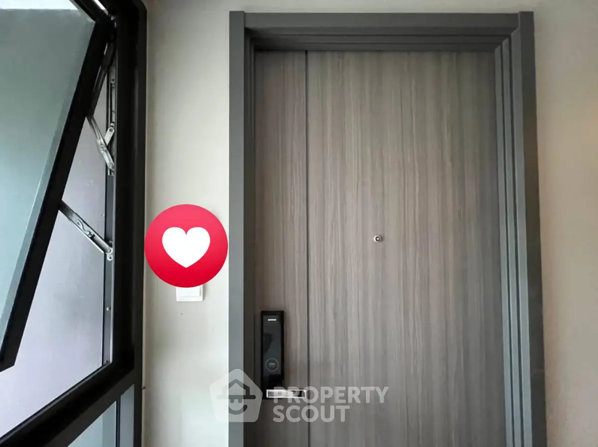 Modern apartment entrance with secure digital lock and stylish wooden door.