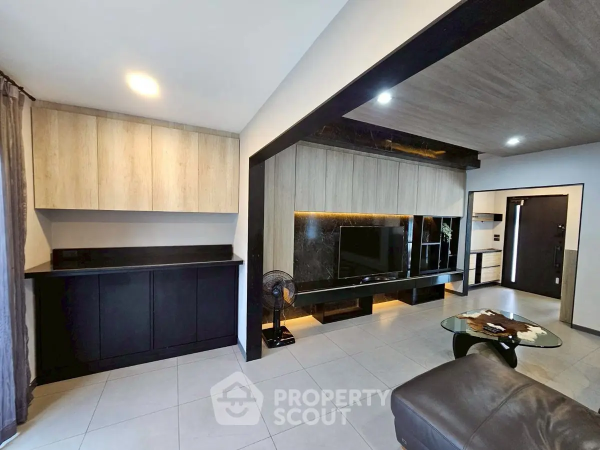Modern living room with sleek cabinetry and stylish decor
