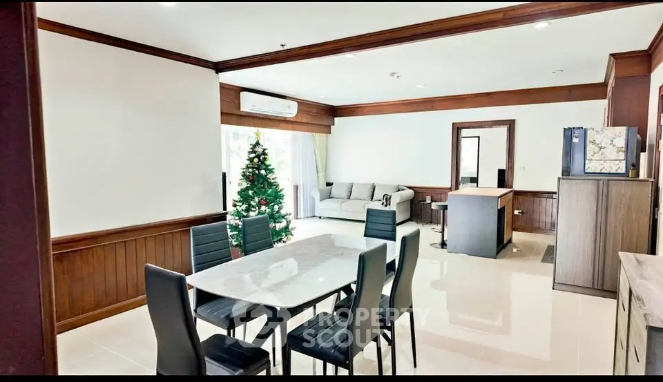 Spacious living room with modern dining area and Christmas decor