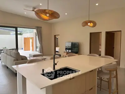 Modern open-plan living room with kitchen island and stylish lighting