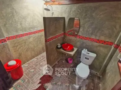 Stylish bathroom with modern red accents and unique tile flooring