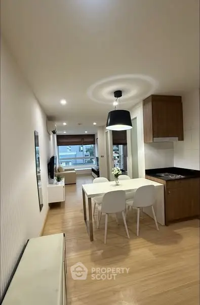 Modern open-plan living and dining area with stylish decor and natural light.