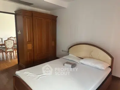 Spacious bedroom with elegant wooden furniture and natural light