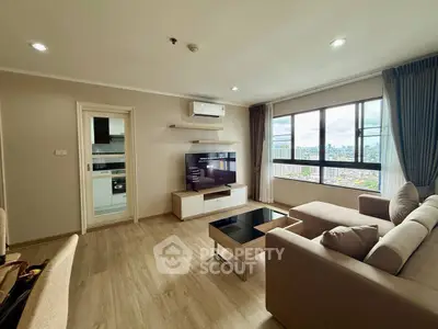 Spacious living room with modern decor and city view