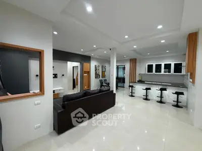 Spacious modern living room with open kitchen and sleek design
