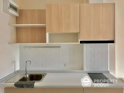 Modern kitchen with sleek cabinetry and electric cooktop