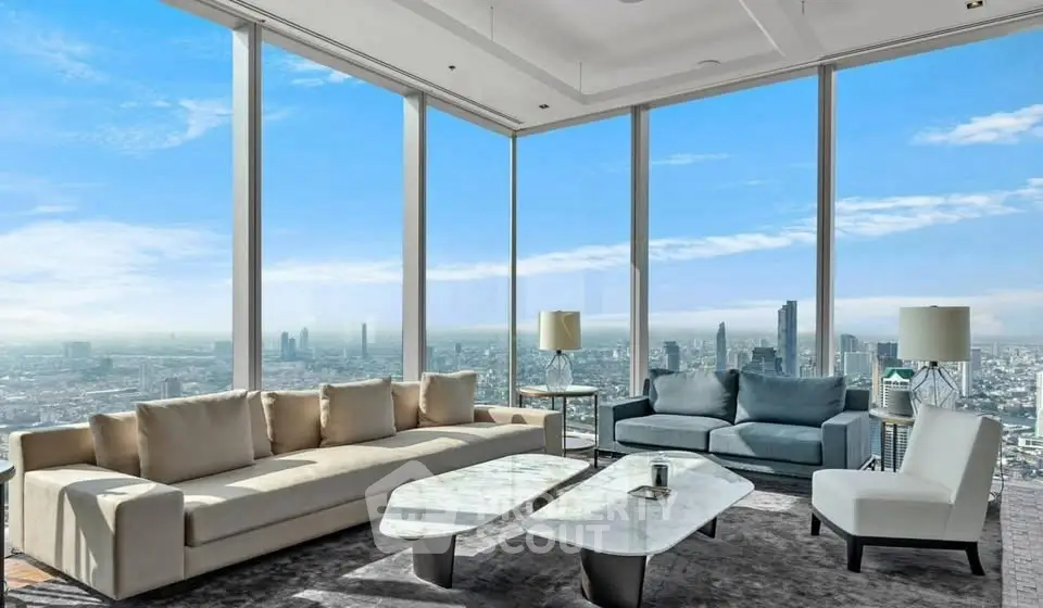 Luxurious living room with panoramic city views and modern furnishings.
