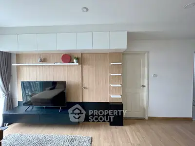 Modern living room with sleek TV setup and stylish wooden paneling.