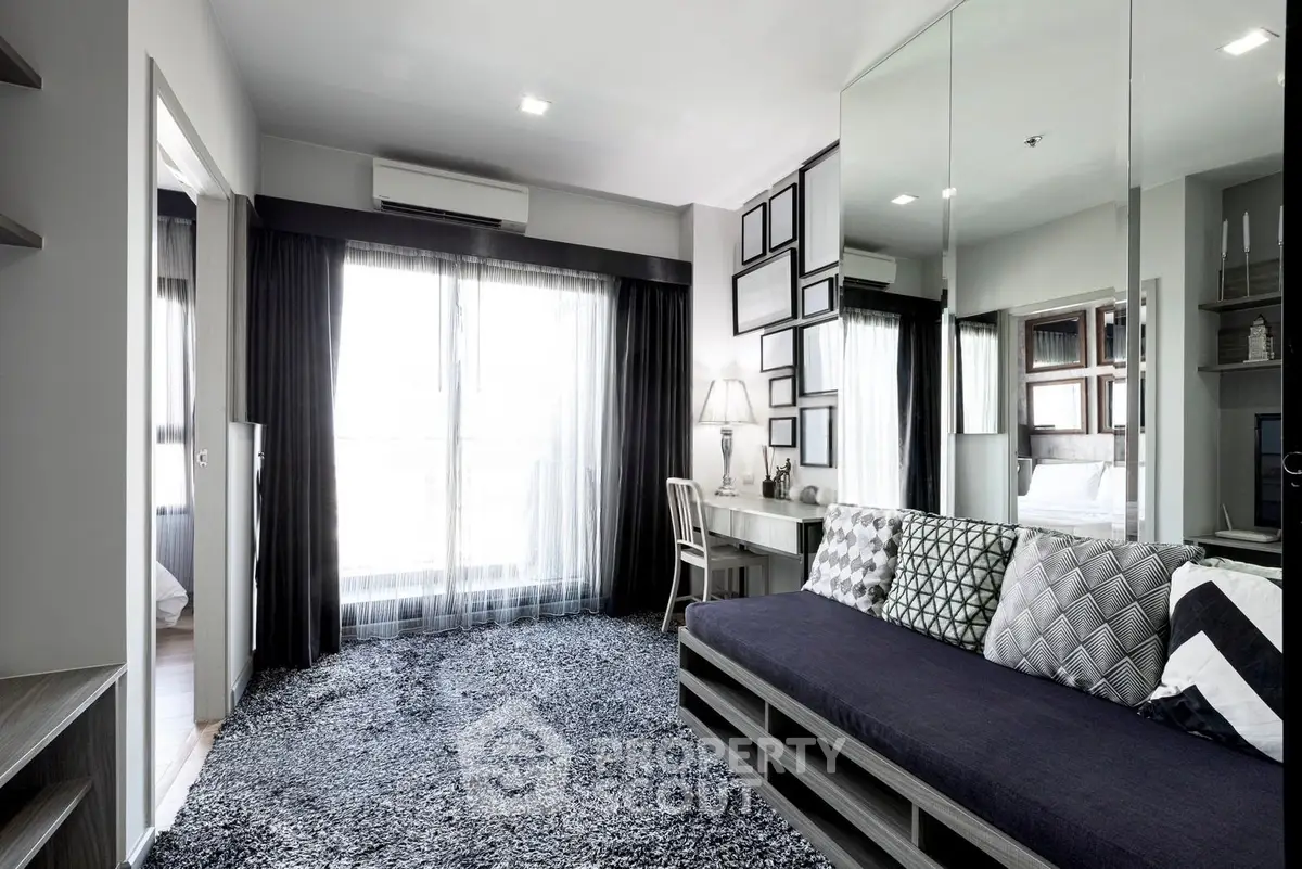 Modern living room with stylish decor and large window for natural light