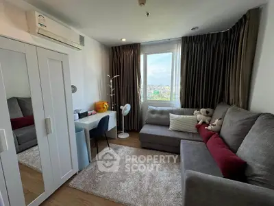 Cozy living room with plush sofa, study desk, and city view window in modern apartment.