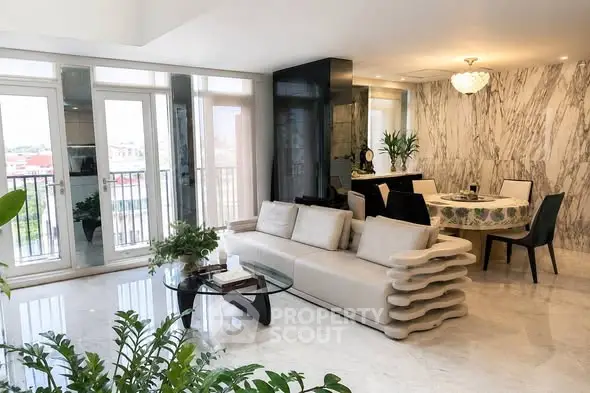 Luxurious modern living room with elegant decor and large windows offering natural light.