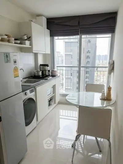 Modern kitchen with sleek appliances and city view from large window.
