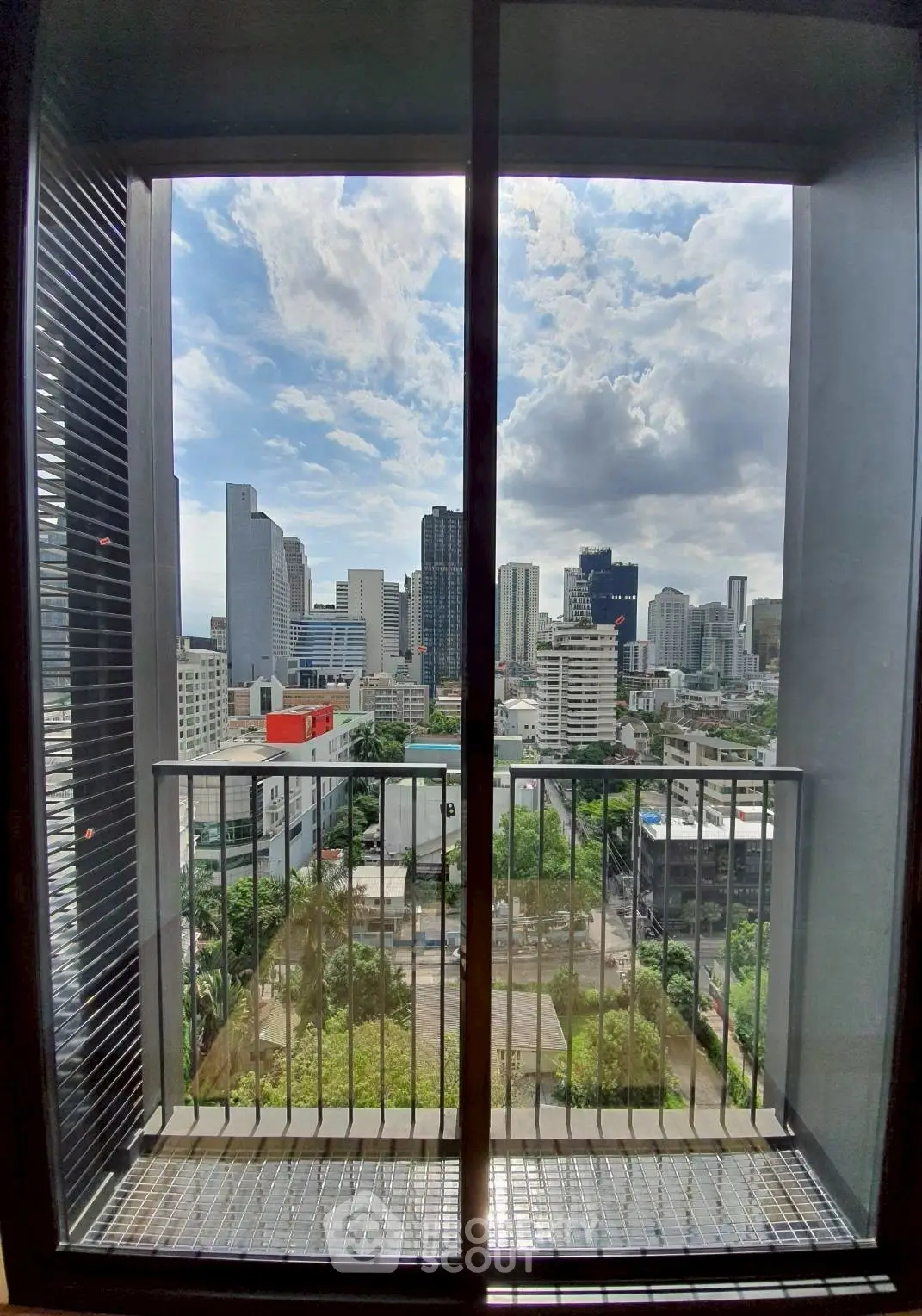 Stunning cityscape view from modern apartment balcony with skyline backdrop.