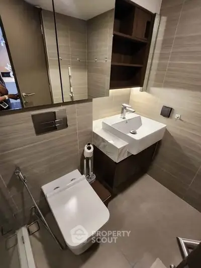 Modern bathroom with sleek fixtures and neutral tiles