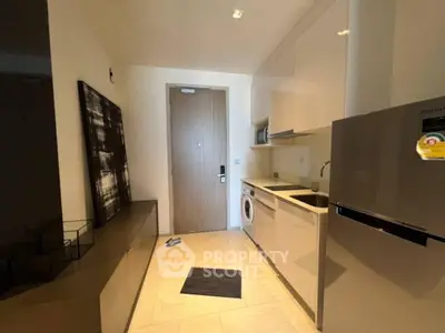 Modern compact kitchen with sleek appliances and washing machine