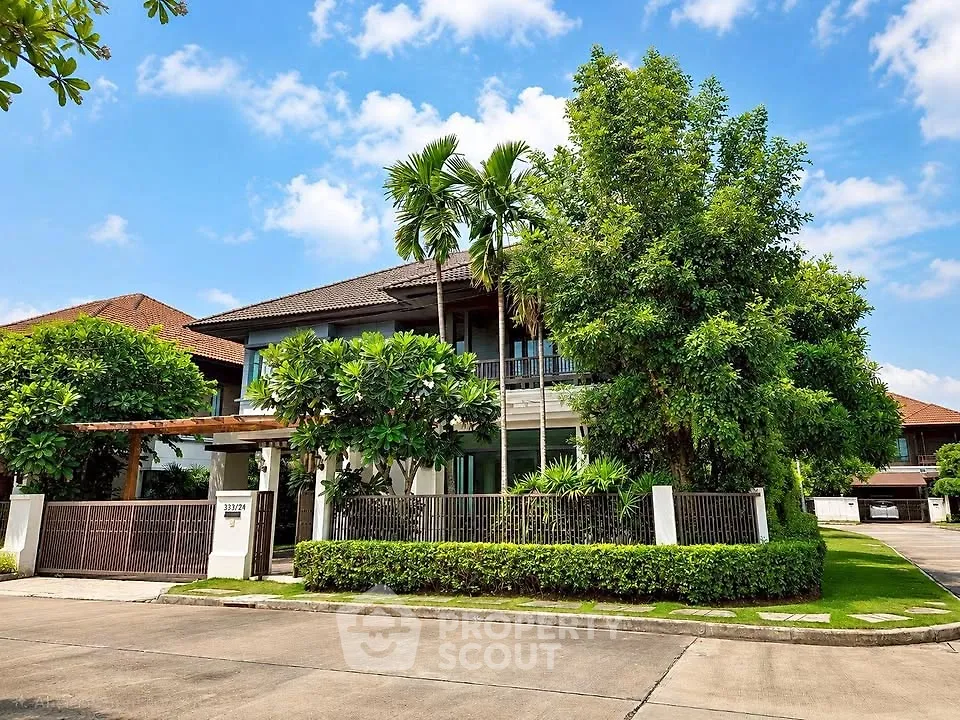 Stunning modern house with lush greenery and spacious driveway in a serene neighborhood.