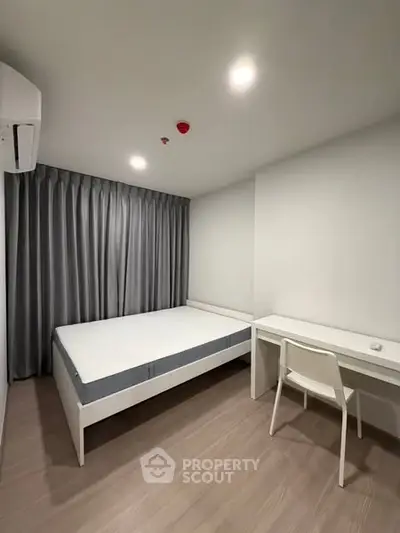 Modern minimalist bedroom with sleek design and natural light