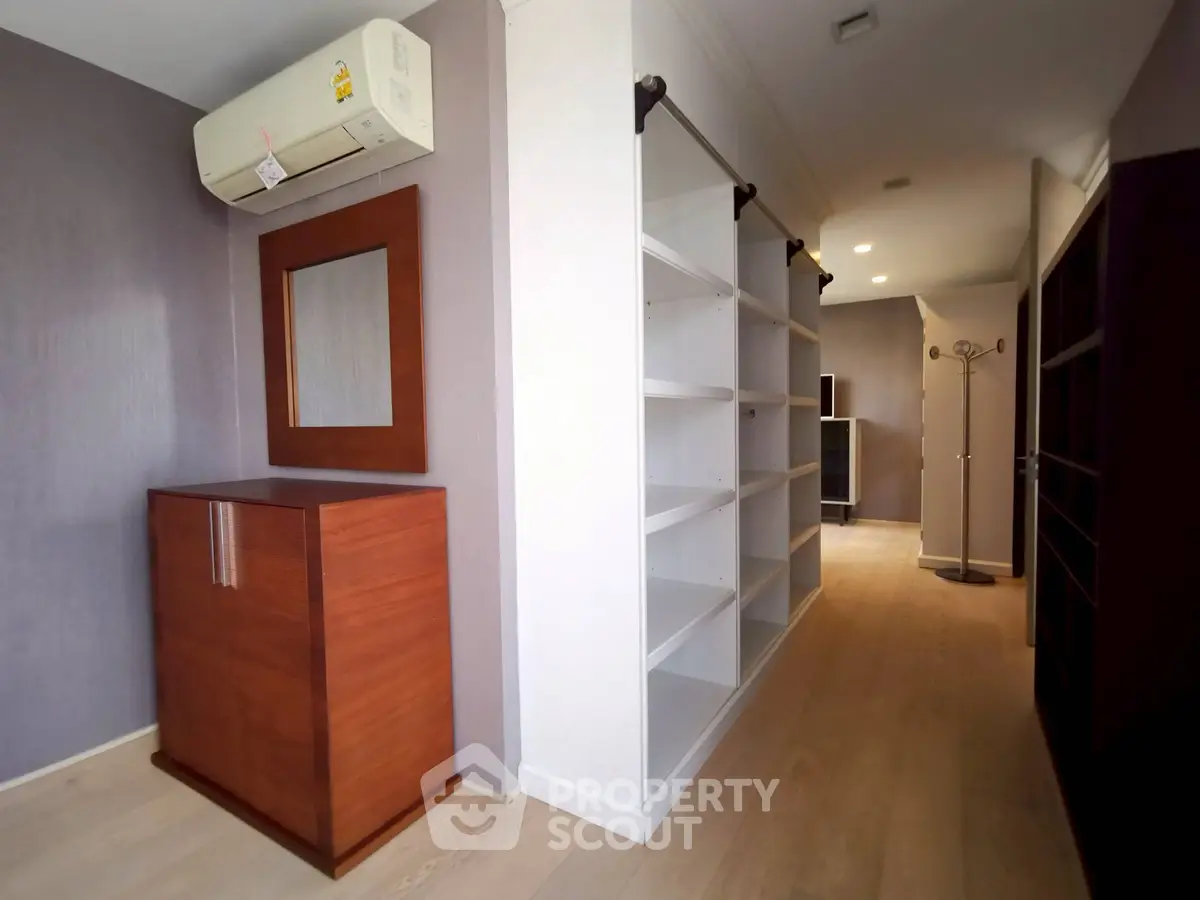 Spacious storage room with modern shelving and air conditioning unit.