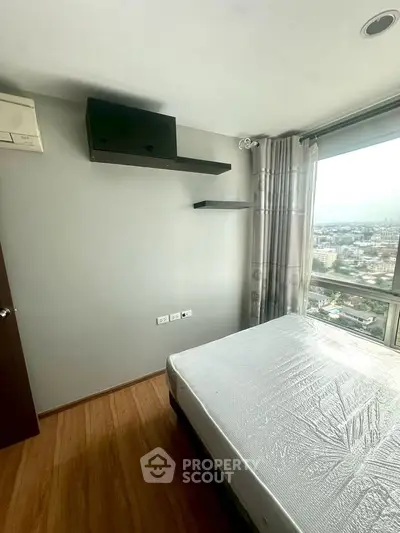 Modern bedroom with city view, featuring sleek shelves and large window for natural light.