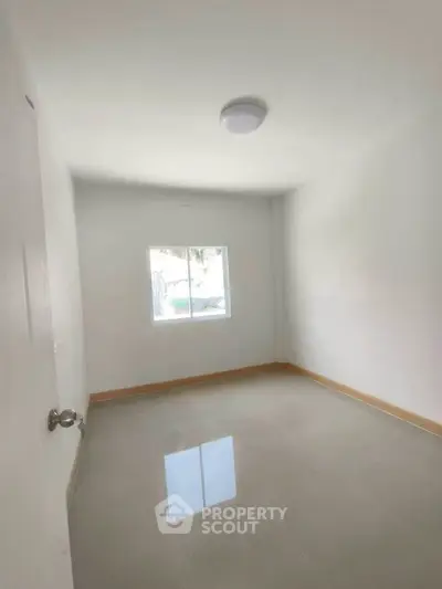 Bright empty room with glossy tiled floor and window, perfect for customization.