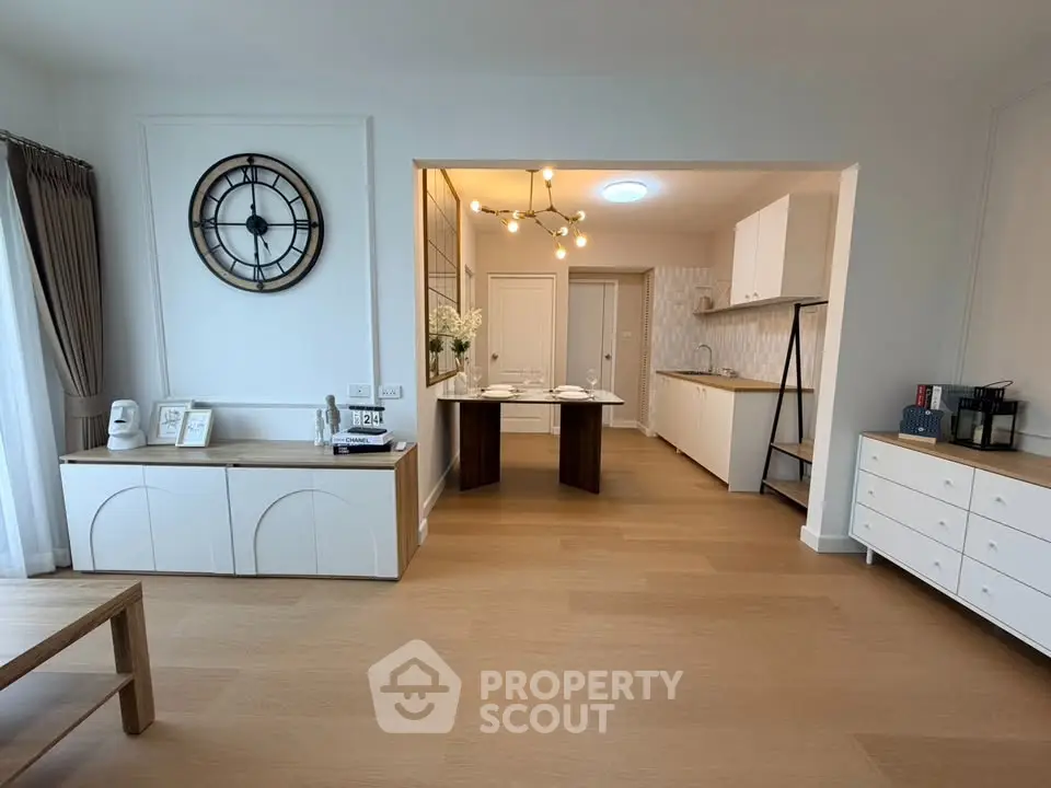 Spacious open-plan living room with modern kitchen and stylish decor
