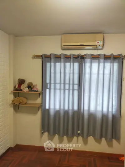 Cozy bedroom with air conditioning and soft lighting, perfect for relaxation.