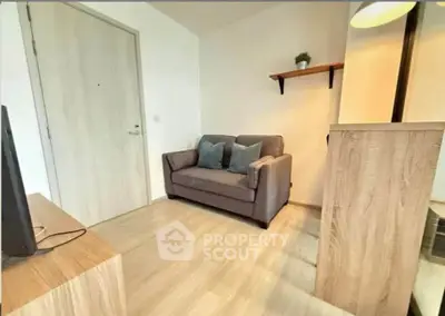 Cozy living room with modern decor and comfortable seating in a stylish apartment.