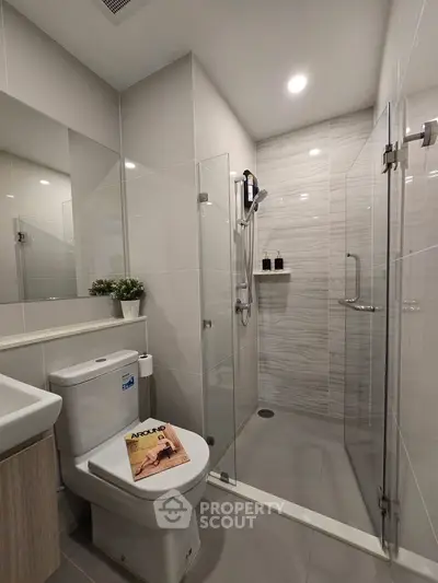 Modern bathroom with glass shower enclosure and sleek fixtures