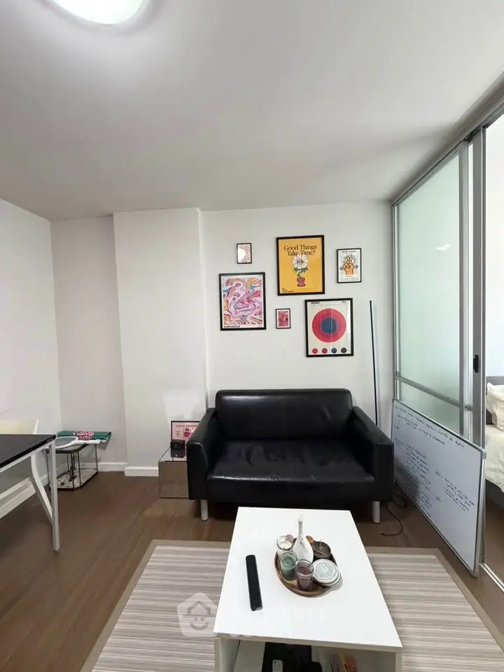 Modern living room with stylish decor and black leather sofa, perfect for urban living.