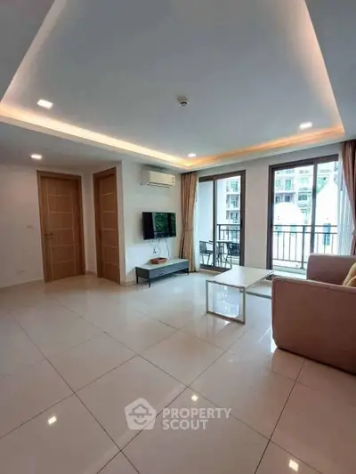 Spacious modern living room with balcony in high-rise apartment